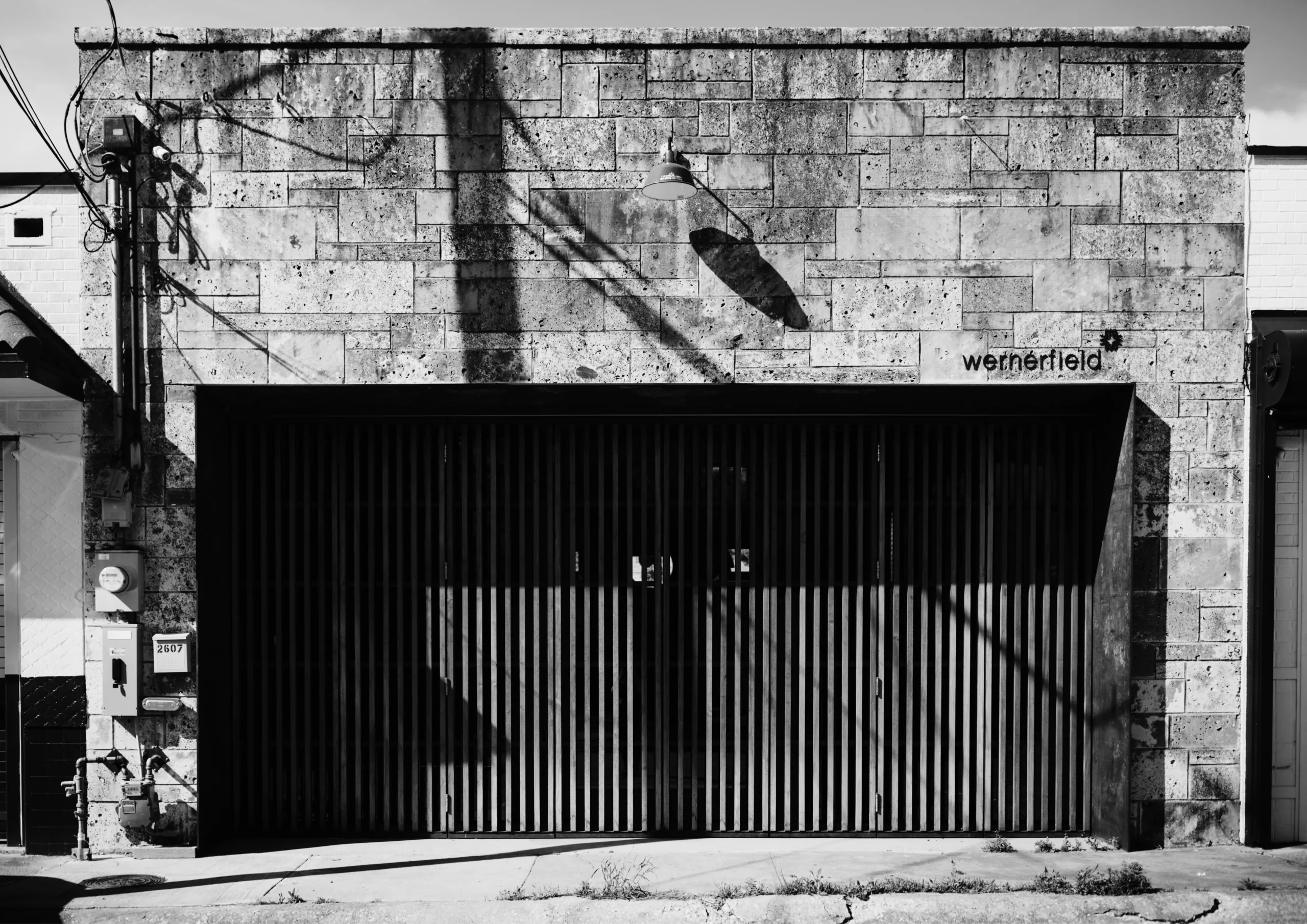 A black and white photograph of a garage door.