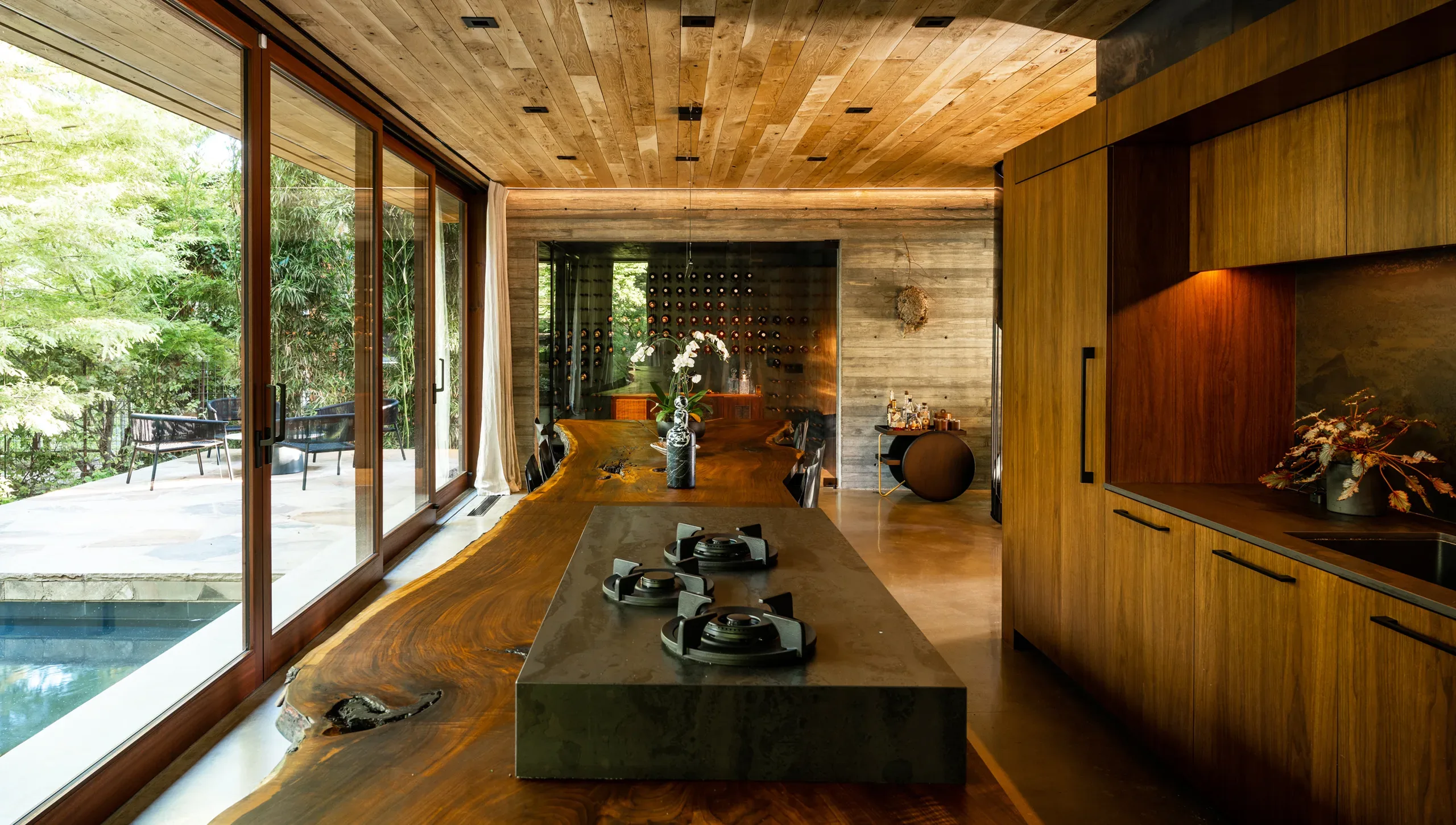 A kitchen with a wooden counter and a wooden ceiling.